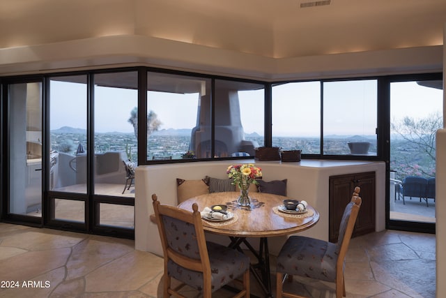 sunroom featuring a mountain view and a wealth of natural light