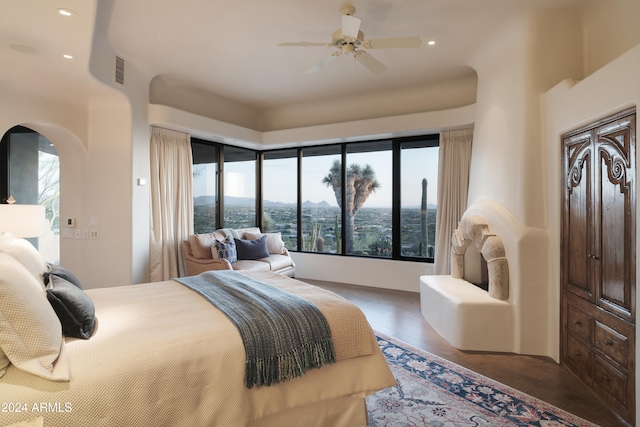 bedroom with dark hardwood / wood-style floors and ceiling fan