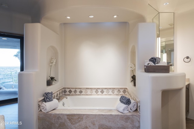 bathroom featuring tiled tub