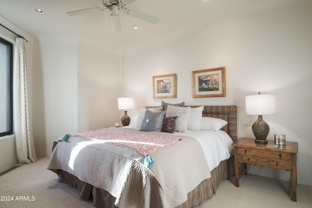 bedroom with light carpet and ceiling fan