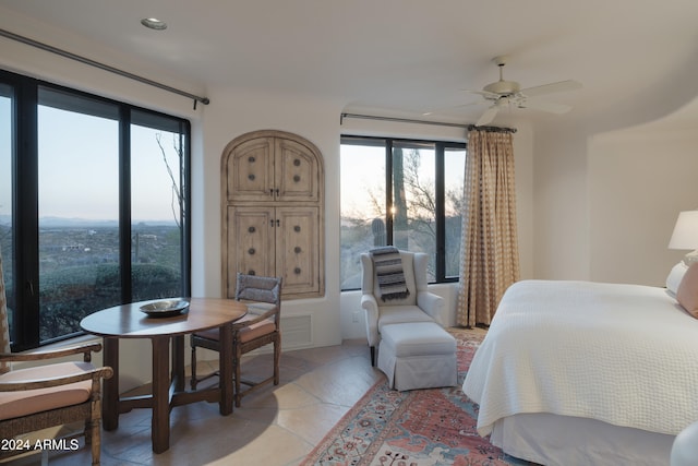 tiled bedroom with ceiling fan