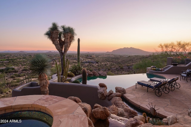 patio terrace at dusk with a mountain view