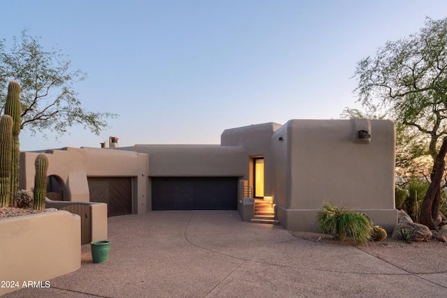 adobe home featuring a garage