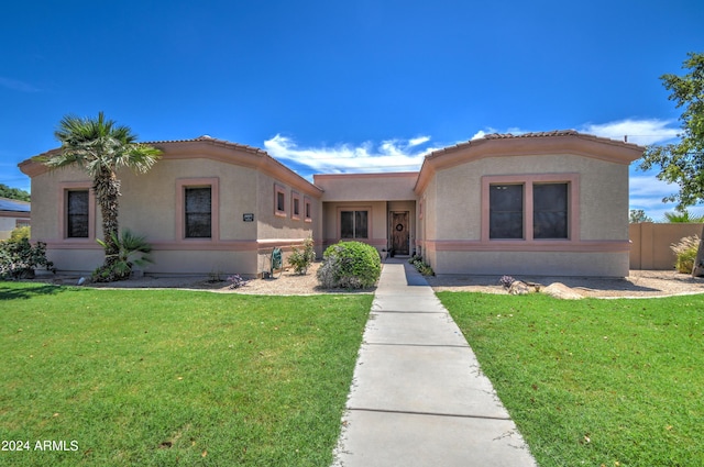 mediterranean / spanish-style house with a front yard