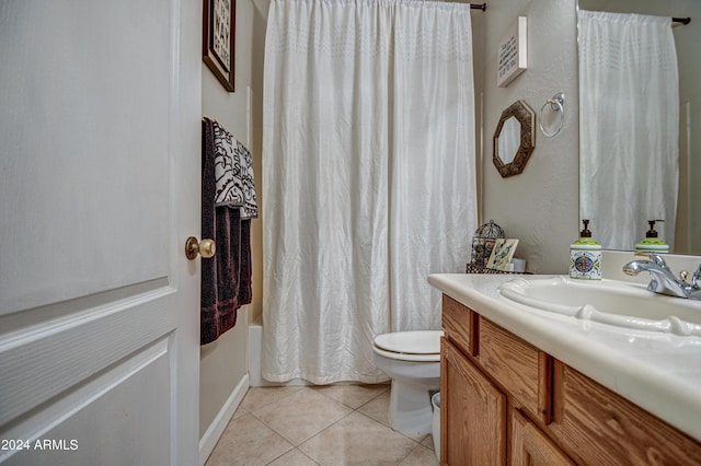 full bathroom with shower / bath combo with shower curtain, tile patterned floors, toilet, and vanity