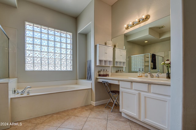 bathroom with tile patterned floors, separate shower and tub, and vanity