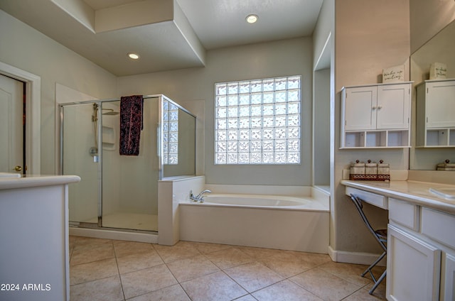 bathroom with vanity, tile patterned floors, and plus walk in shower