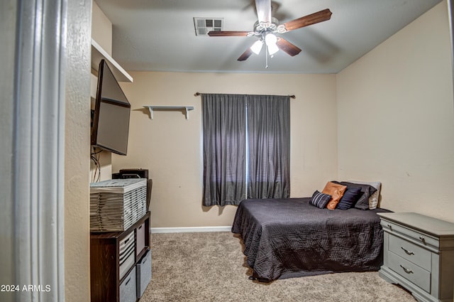 bedroom with ceiling fan and light carpet