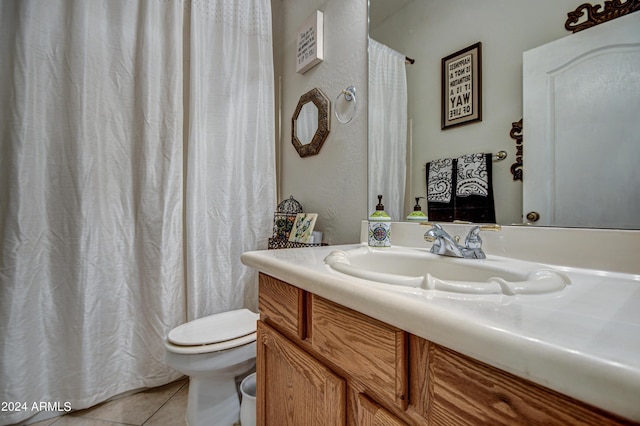 bathroom with vanity, tile patterned floors, and toilet