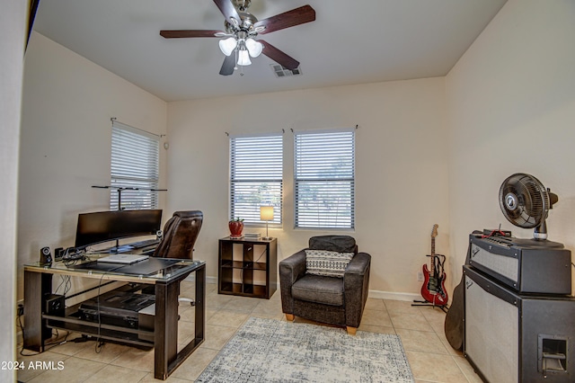 tiled office space featuring ceiling fan