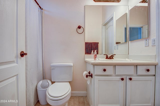 bathroom with tile patterned flooring, vanity, and toilet