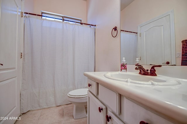 bathroom featuring tile patterned flooring, vanity, curtained shower, and toilet