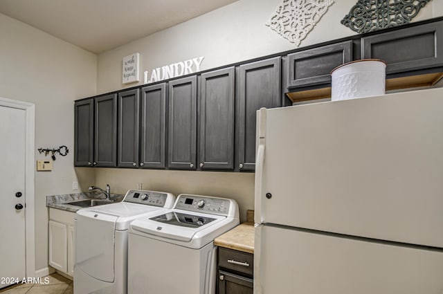 clothes washing area with separate washer and dryer, sink, light tile patterned floors, and cabinets