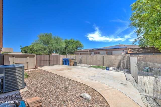 view of yard with central AC and a patio area