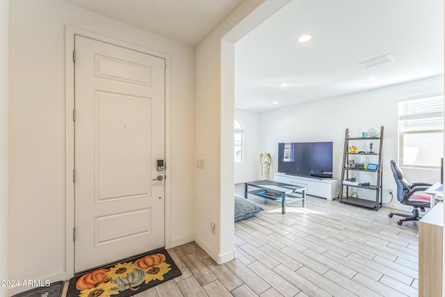 entrance foyer with a wealth of natural light and light hardwood / wood-style floors