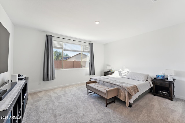 bedroom featuring light colored carpet