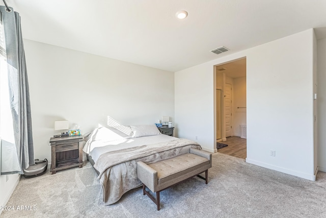 carpeted bedroom with ensuite bath