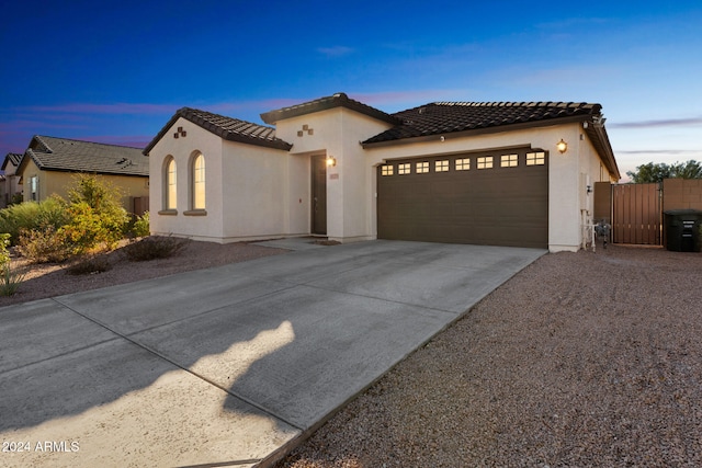 mediterranean / spanish home featuring a garage