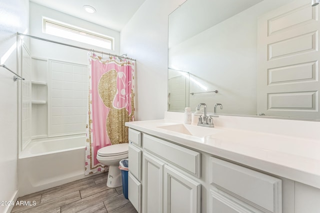 full bathroom with hardwood / wood-style flooring, vanity, toilet, and shower / tub combo