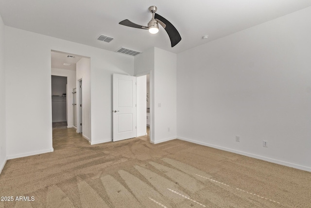 unfurnished bedroom featuring a ceiling fan, baseboards, visible vents, and carpet flooring