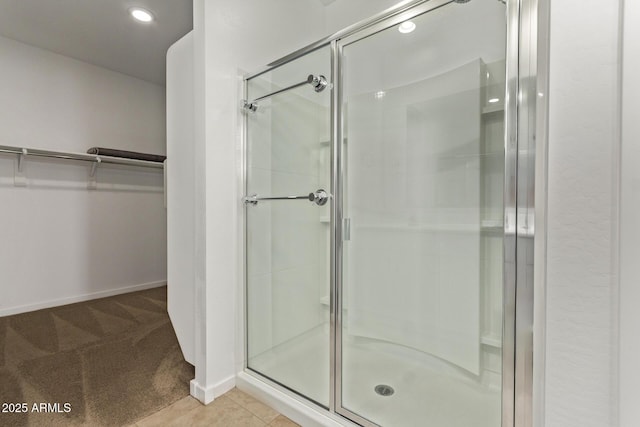 full bathroom with a shower stall and a spacious closet