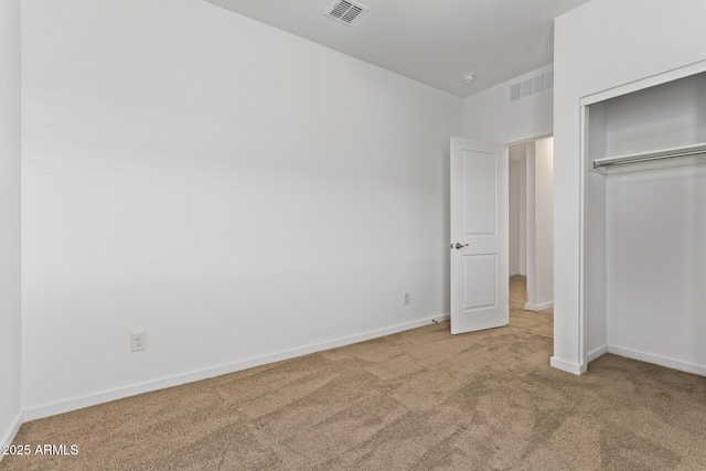 unfurnished bedroom featuring carpet floors, baseboards, visible vents, and a closet