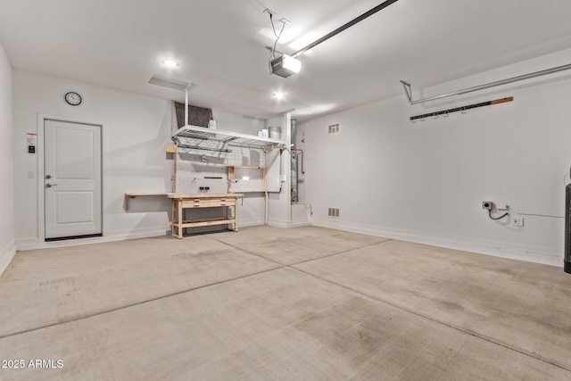 garage with baseboards, visible vents, and a garage door opener