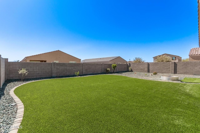 view of yard with a fenced backyard