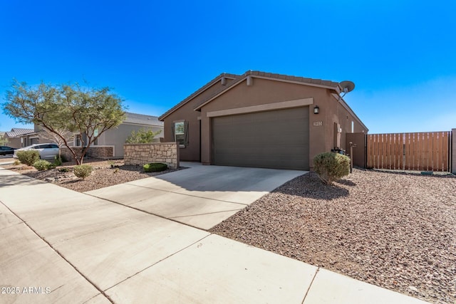 ranch-style home featuring a garage, fence, driveway, a gate, and stucco siding