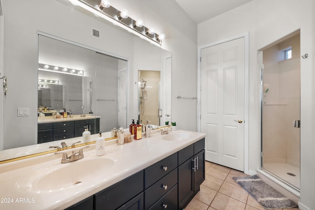 bathroom featuring vanity, walk in shower, and tile patterned floors