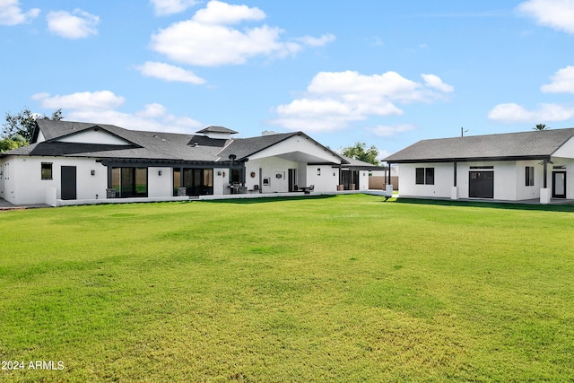 rear view of house featuring a lawn