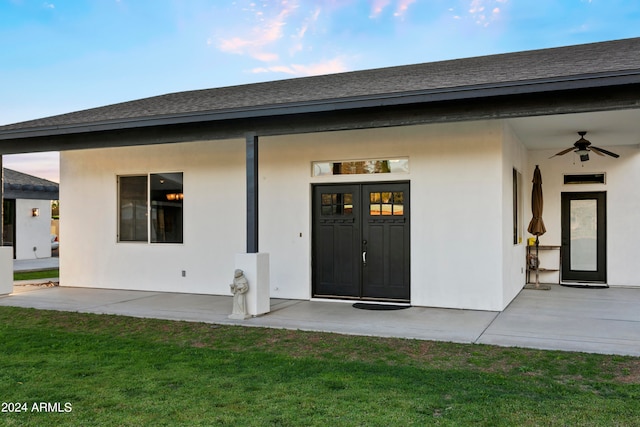 property entrance with a patio, a yard, and ceiling fan