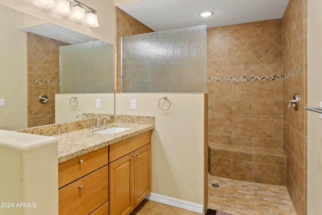 bathroom featuring vanity and tiled shower