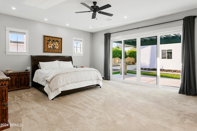 bedroom with light carpet, multiple windows, access to exterior, and ceiling fan