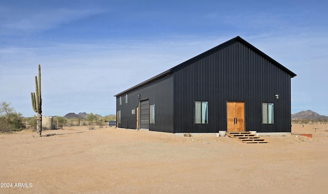 exterior space featuring a mountain view and an outbuilding