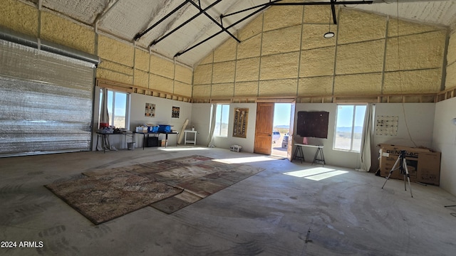 miscellaneous room featuring lofted ceiling and concrete floors