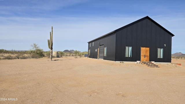 back of property featuring an outdoor structure