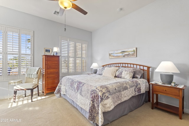 carpeted bedroom featuring baseboards, visible vents, and a ceiling fan