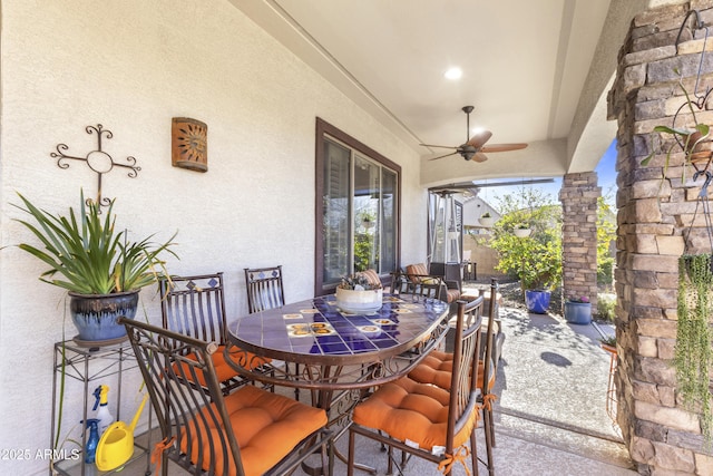 view of patio / terrace with a ceiling fan and outdoor dining space