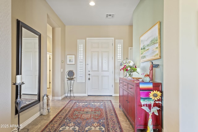 foyer with visible vents, baseboards, and light tile patterned flooring