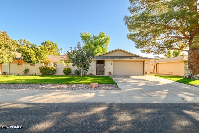 ranch-style home featuring a front lawn and a garage