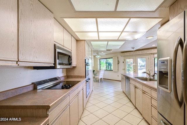 kitchen featuring french doors, stainless steel appliances, ceiling fan, sink, and light tile patterned floors