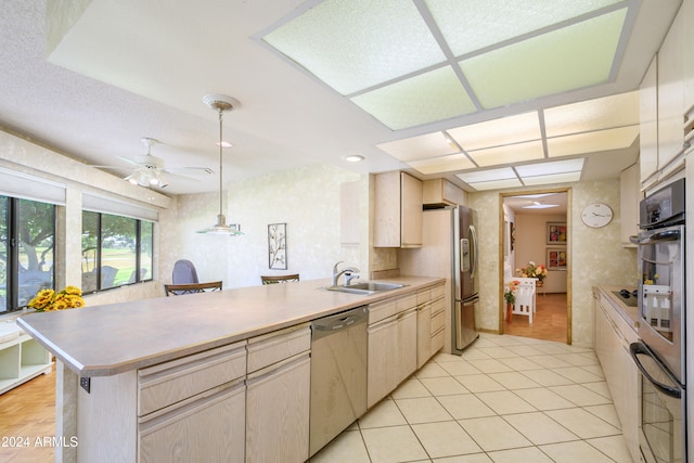 kitchen featuring hanging light fixtures, sink, ceiling fan, appliances with stainless steel finishes, and kitchen peninsula