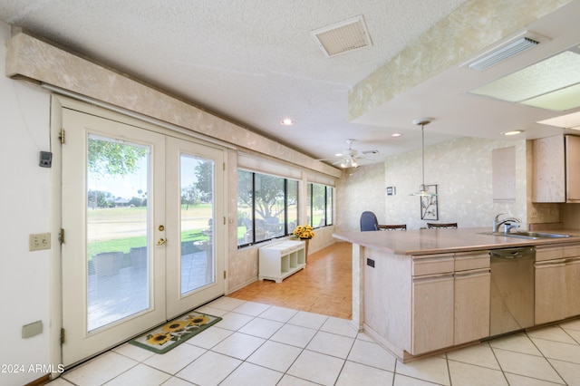 kitchen featuring french doors, sink, stainless steel dishwasher, ceiling fan, and decorative light fixtures