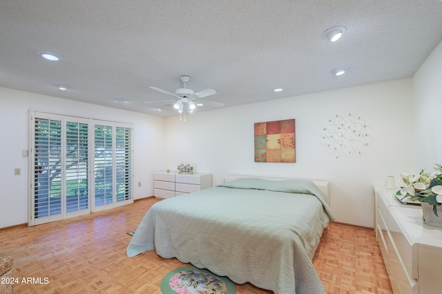 bedroom featuring access to exterior, a textured ceiling, light parquet floors, and ceiling fan