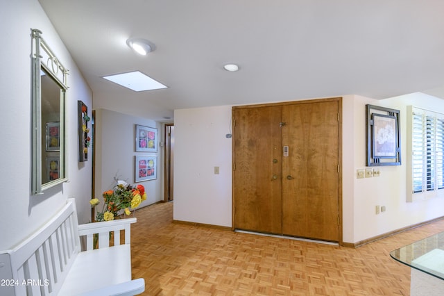 interior space with a skylight and light parquet flooring