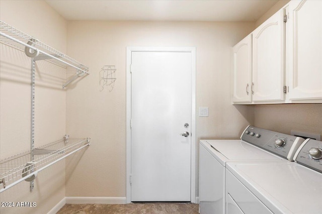 laundry room with washer and clothes dryer, cabinets, and light tile patterned floors