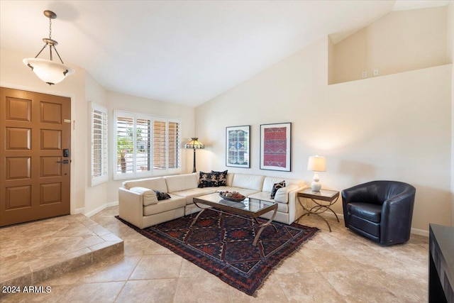 living room featuring light tile patterned flooring and high vaulted ceiling