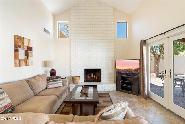 living room with high vaulted ceiling, light tile patterned flooring, a fireplace, and french doors