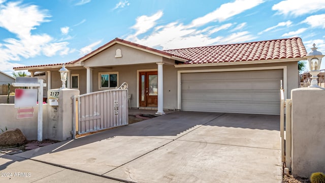 view of front facade featuring a porch and a garage